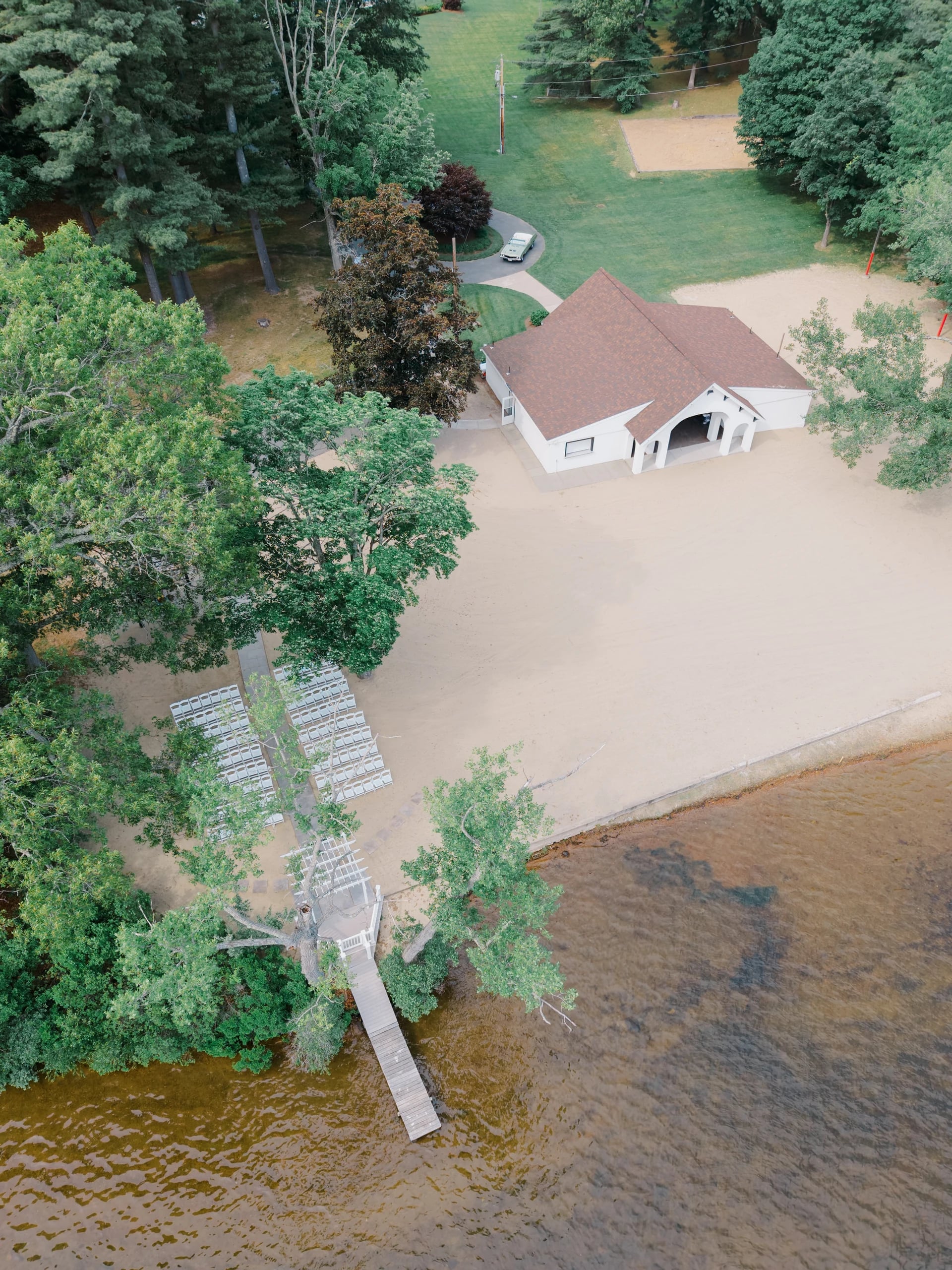 Aerial view of the Boat House pavilion and private beach ceremony setup at Lake Pearl Wrentham